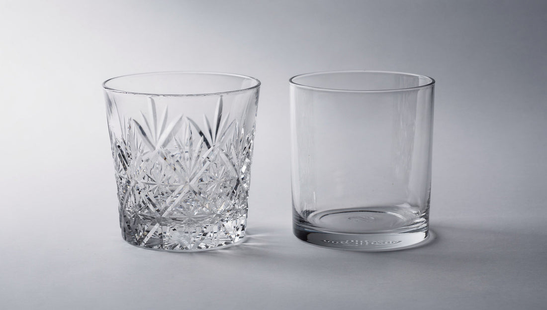One cut glass beside a smooth uncut glass blank on pale grey.
