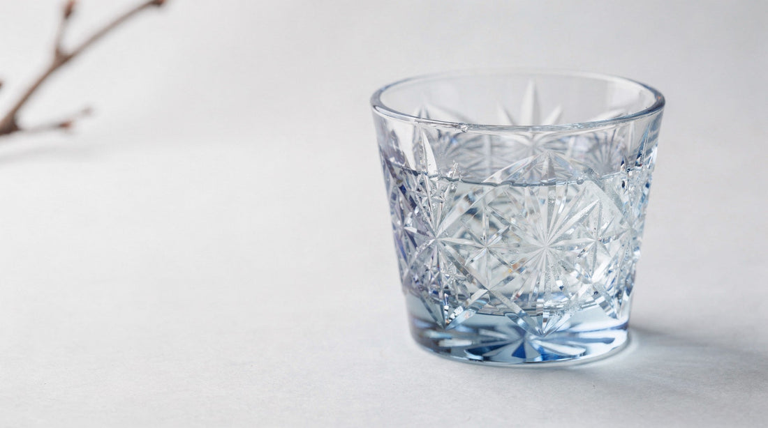A mist-blue Japanese cut-glass sake cup in thin spring north-window light