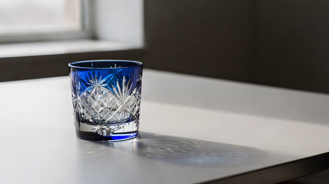 A contemporary room edge with a window and one cobalt Japanese cut glass