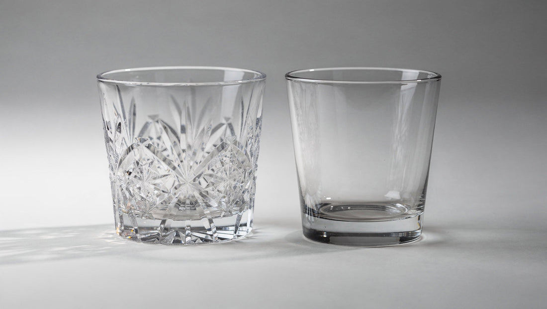 A sharp-cut Japanese glass beside a cheaper rounded pressed-glass tumbler on a pale ground.