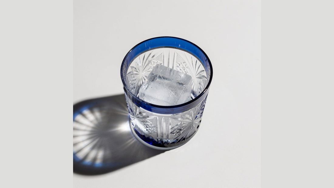 Top-down view of a Japanese cut-glass rocks glass holding one large ice cube
