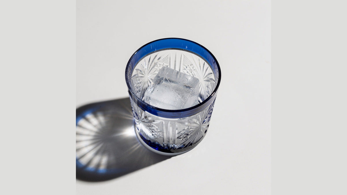 Top-down view of a Japanese cut-glass rocks glass holding one large ice cube