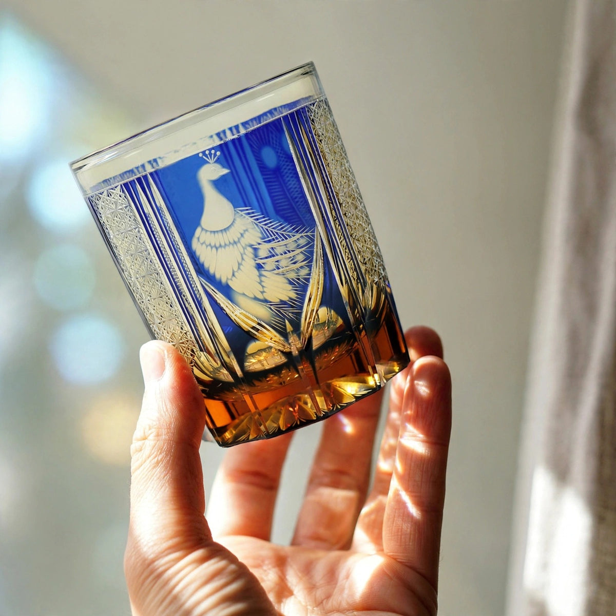 Amber Peacock Whisky Glass, hand held proof of use
